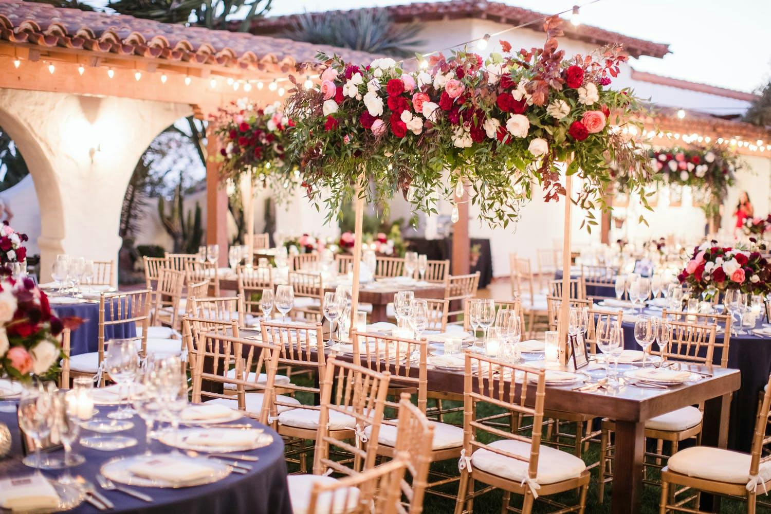 Mediterranean-Style Elevated Rose Wedding Centerpieces With Cascades of Greenery | PartySlate