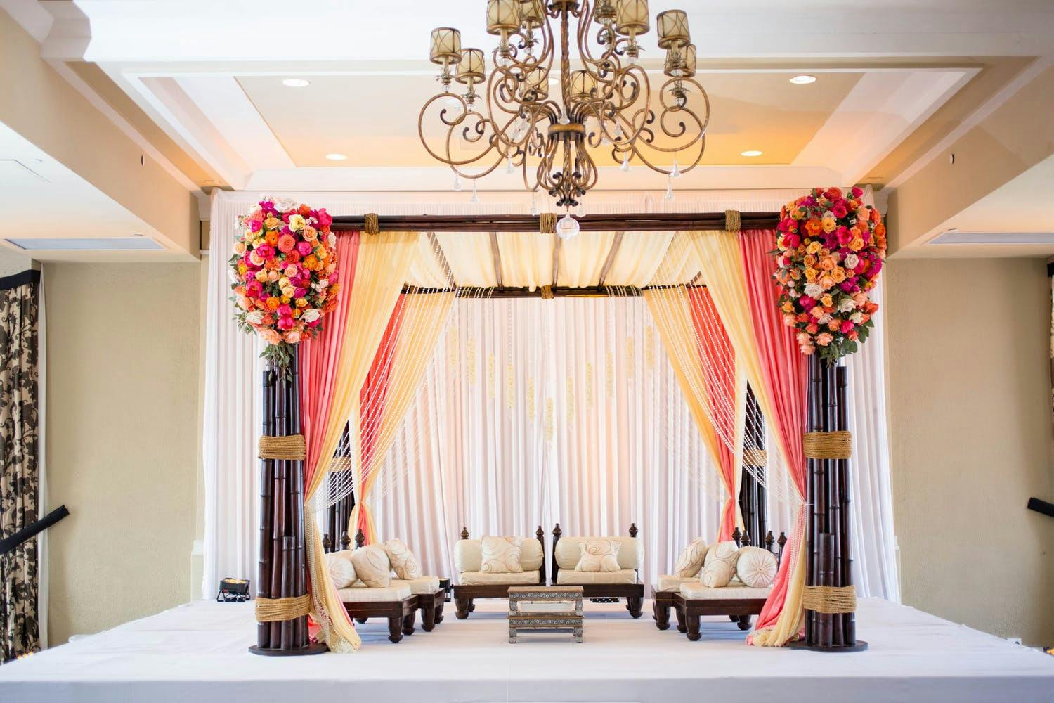 Mandap With Beachy Corals, Dark Bamboo, and Strung Pearls | PartySlate