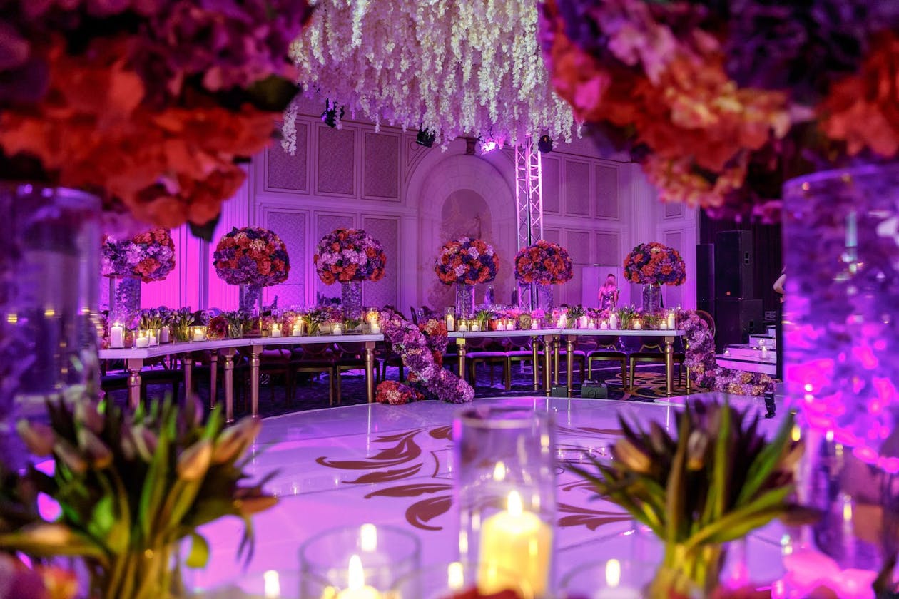 Ceiling of Suspended White Flowers With Red Rose Centerpieces in Foreground | PartySlate
