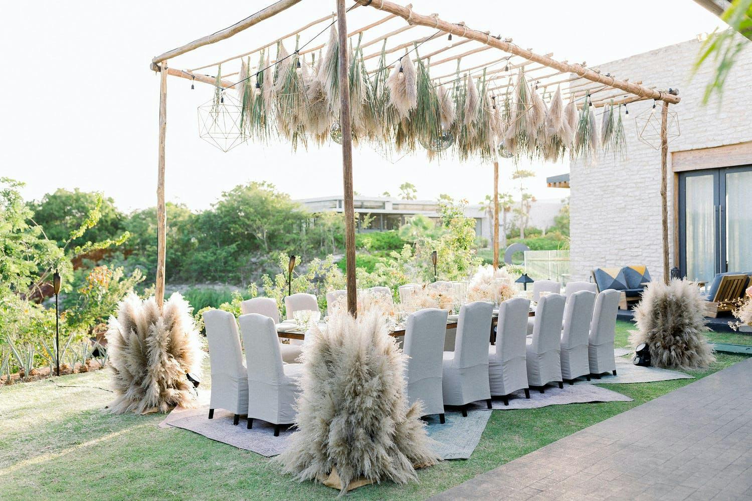 Wedding Tablescape With Wooden Canopy and Pampas Grass Fringe | PartySlate