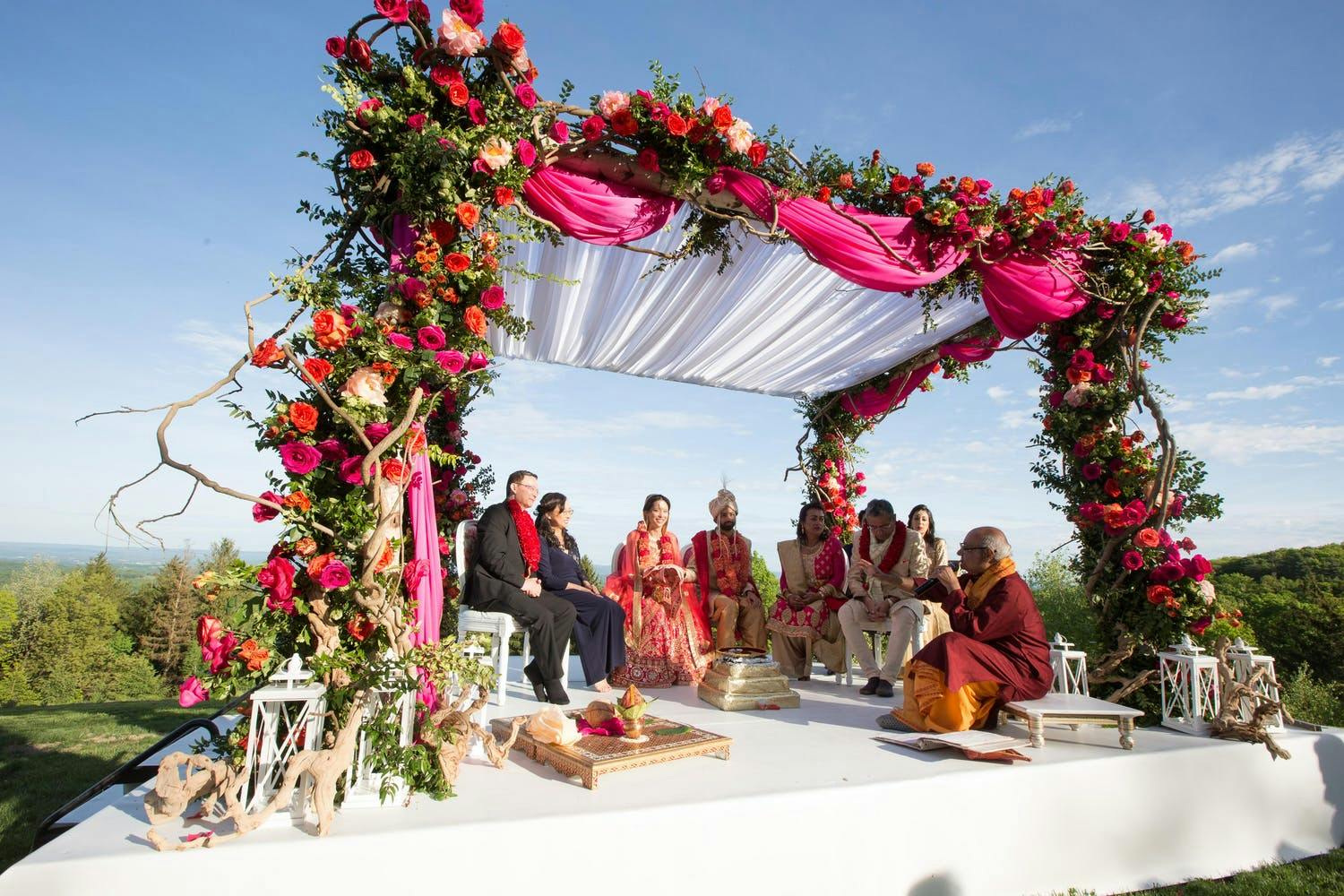 Mandap With Curving Branches and Rich Florals | PartySlate