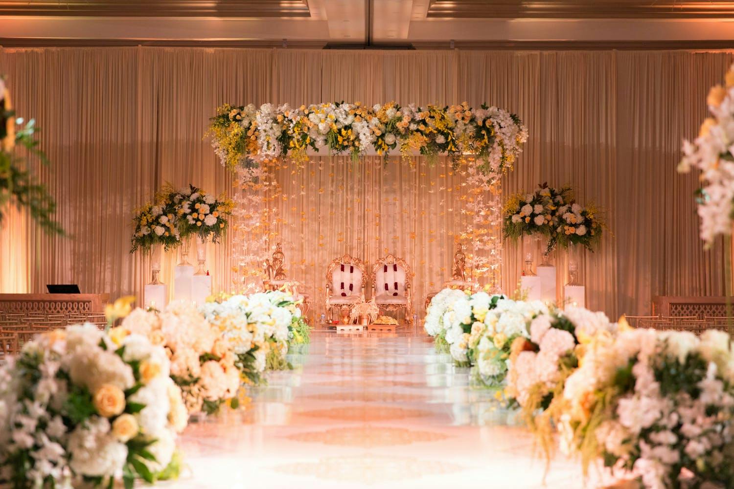 Mandap With Summery Golden Florals and Suspended Flower Tassels | PartySlate