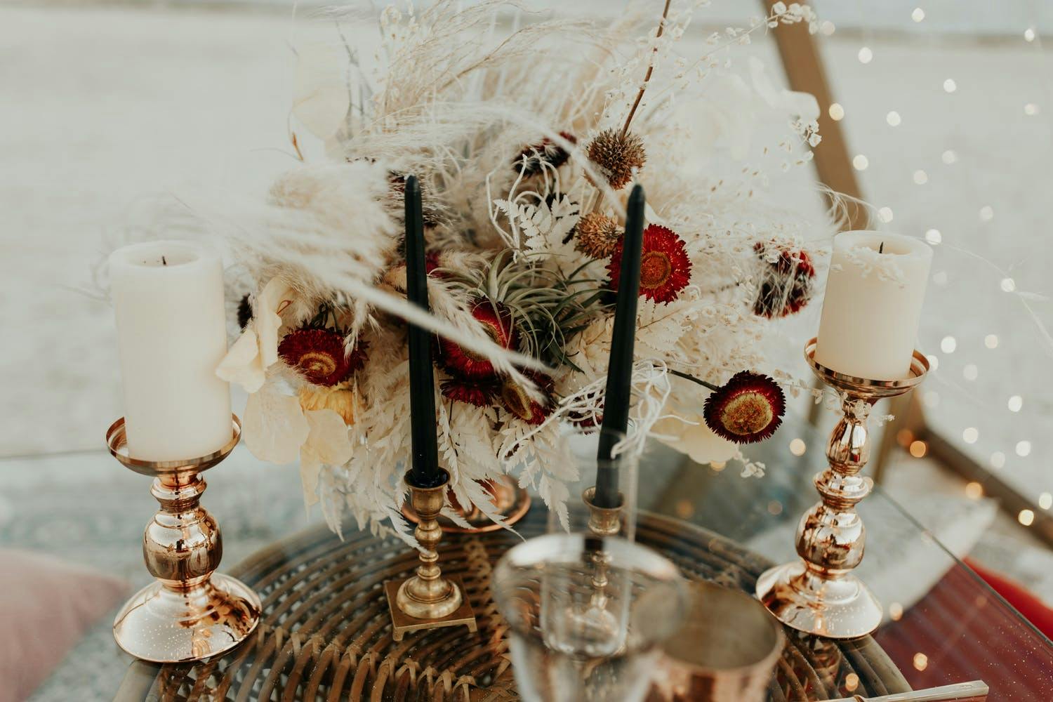 Boho-Chic Beach Wedding Centerpiece With Pampas Grass and Black Tallow Candles | PartySlate