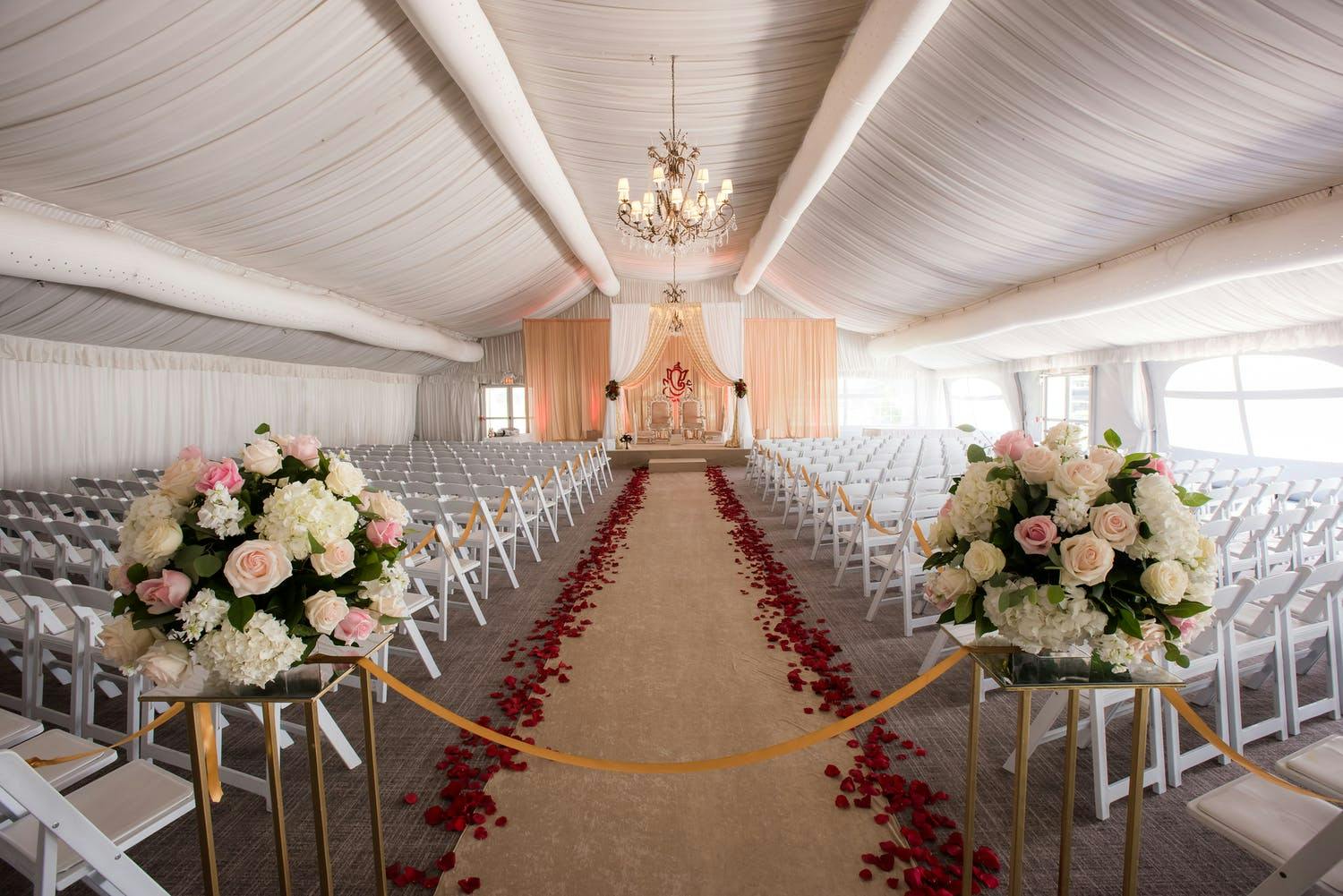 Mandap With Ethereal Gold Fabric and Floral Wall Accent | PartySlate