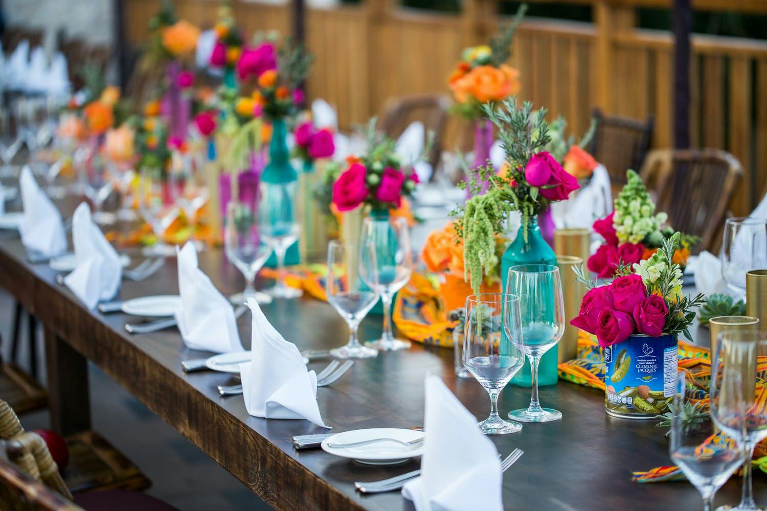 Beach Wedding Centerpiece With Colorful Glassware and Blooms | PartySlate
