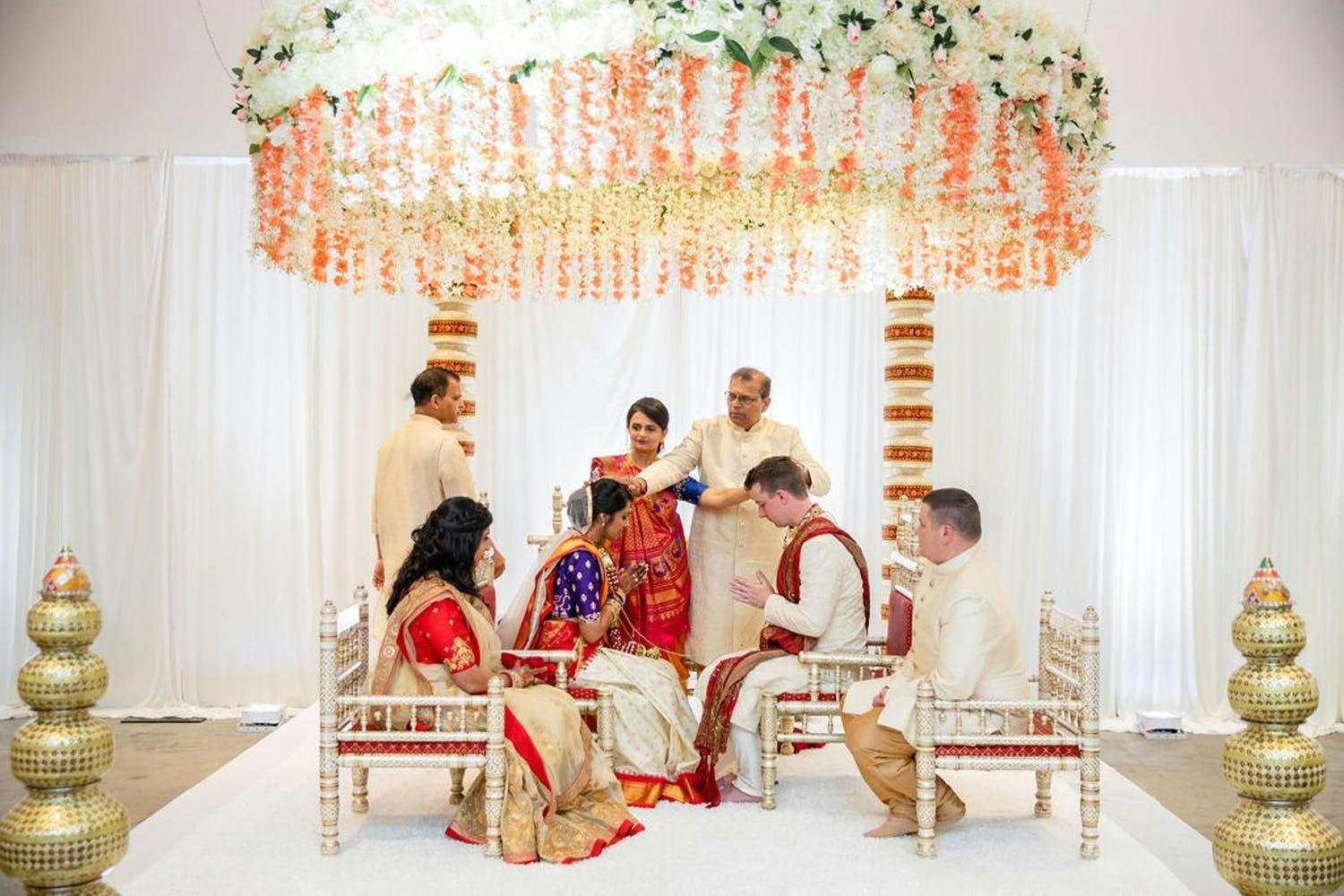 Mandap With Circlet of Orange and White Floral Fringe | PartySlate