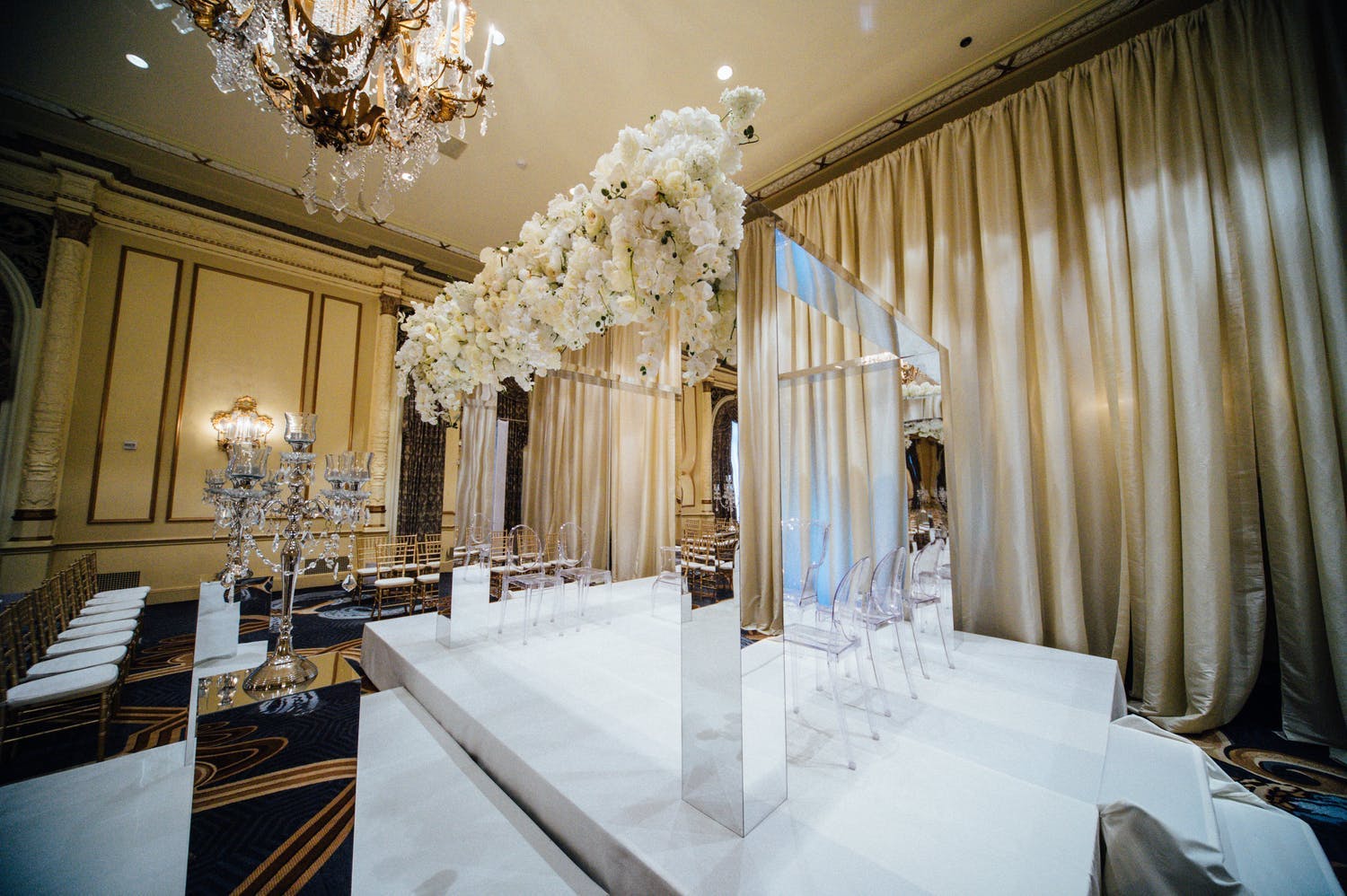 Mandap With Mirrored Structure and Draped White Florals | PartySlate