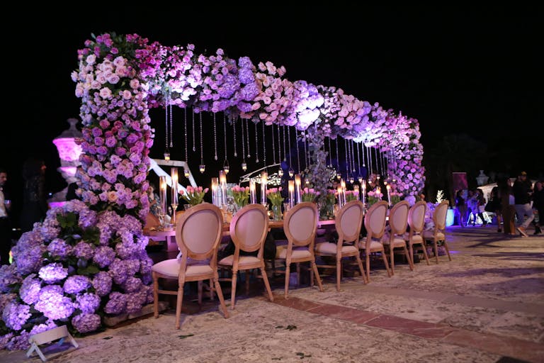 Vizcaya Miami Wedding Reception With King's Table and Elevated Purple Hydrangea Centerpiece Cascading Off One Side of Table | PartySlate