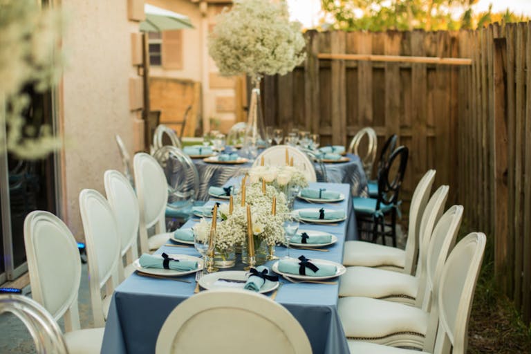 Tablescape With Light Blue Linen, White Modern Seating, and Baby's Breath Centerpieces | PartySlate
