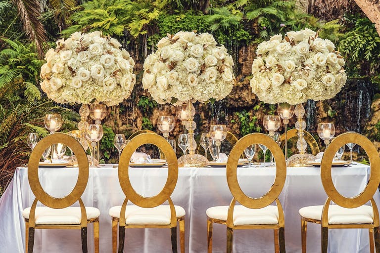 Wedding Tablescape With Gold Seating and Elevated White Floral Centerpieces | PartySlate