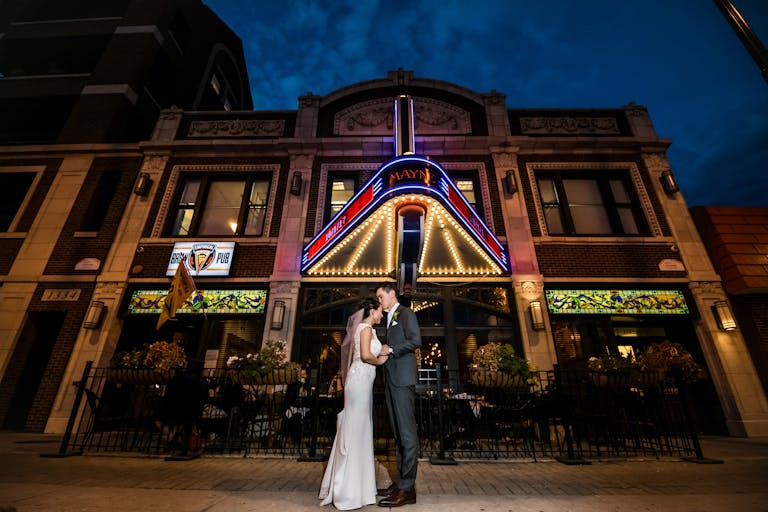 Couple Embrace for Wedding Photo Op Outside of Mayne Stage in Chicago, IL | PartySlate