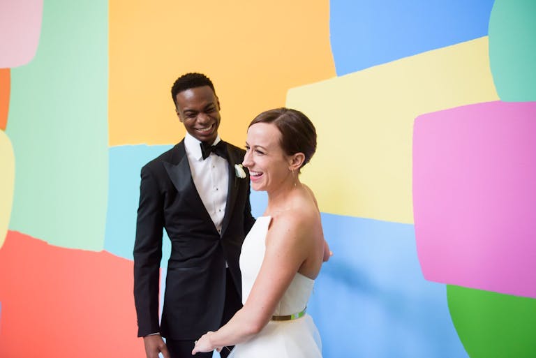 Bride and Groom Pose in Front of Colorful Abstract Painting for Wedding at Museum of Contemporary Art Chicago | PartySlate