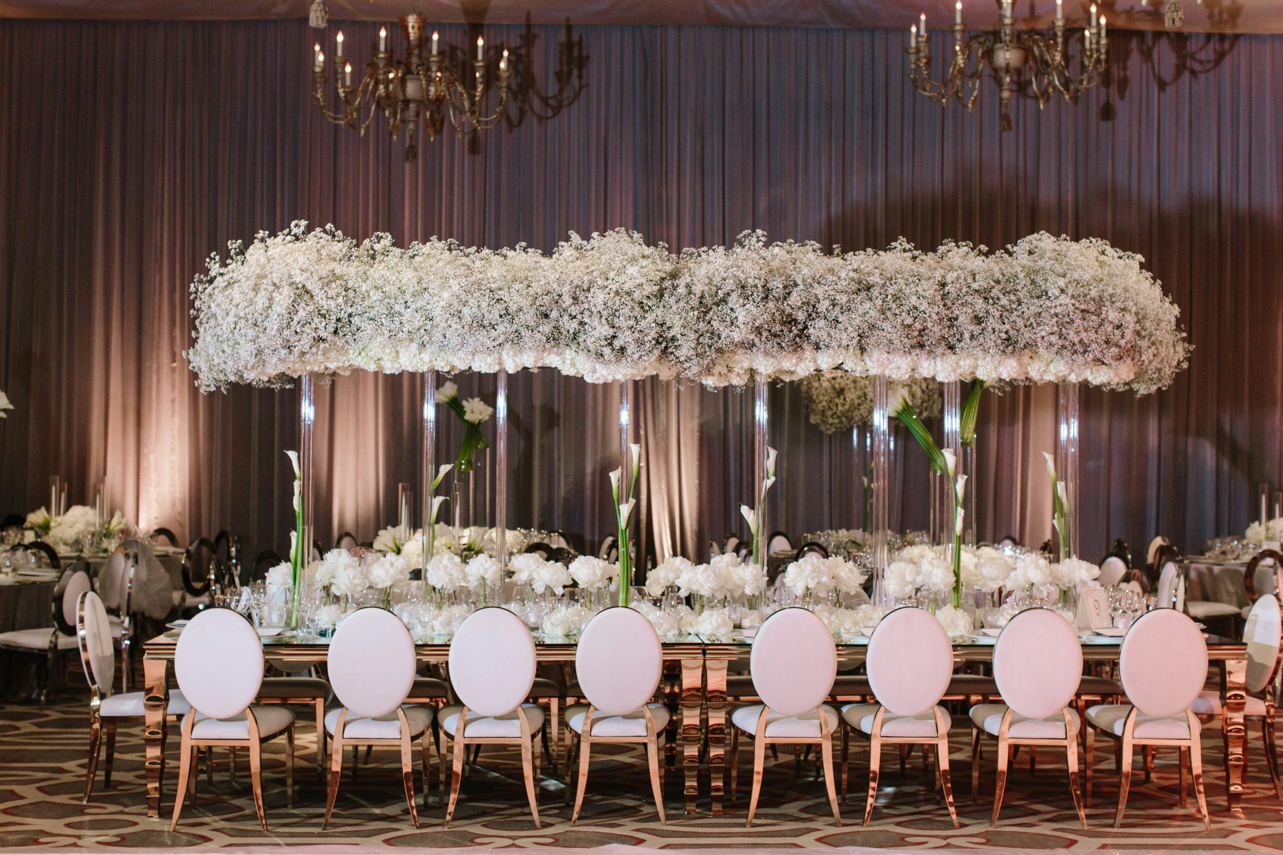 Modern, All-White Wedding Tablescape with Elevated Baby’s Breath Centerpieces | PartySlate