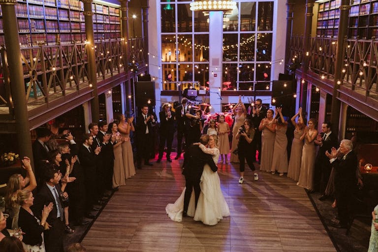Bride and Groom Dance at The Library at 190 South LaSalle, Surrounded by Books | PartySlate