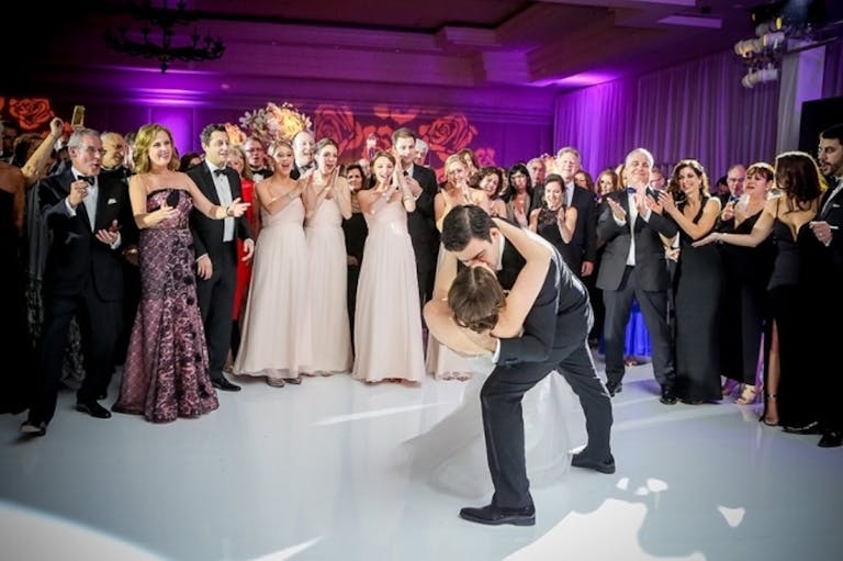 Bride and Groom Kiss on White Polished Dance Floor at The Ritz-Carlton, South Beach | PartySlate