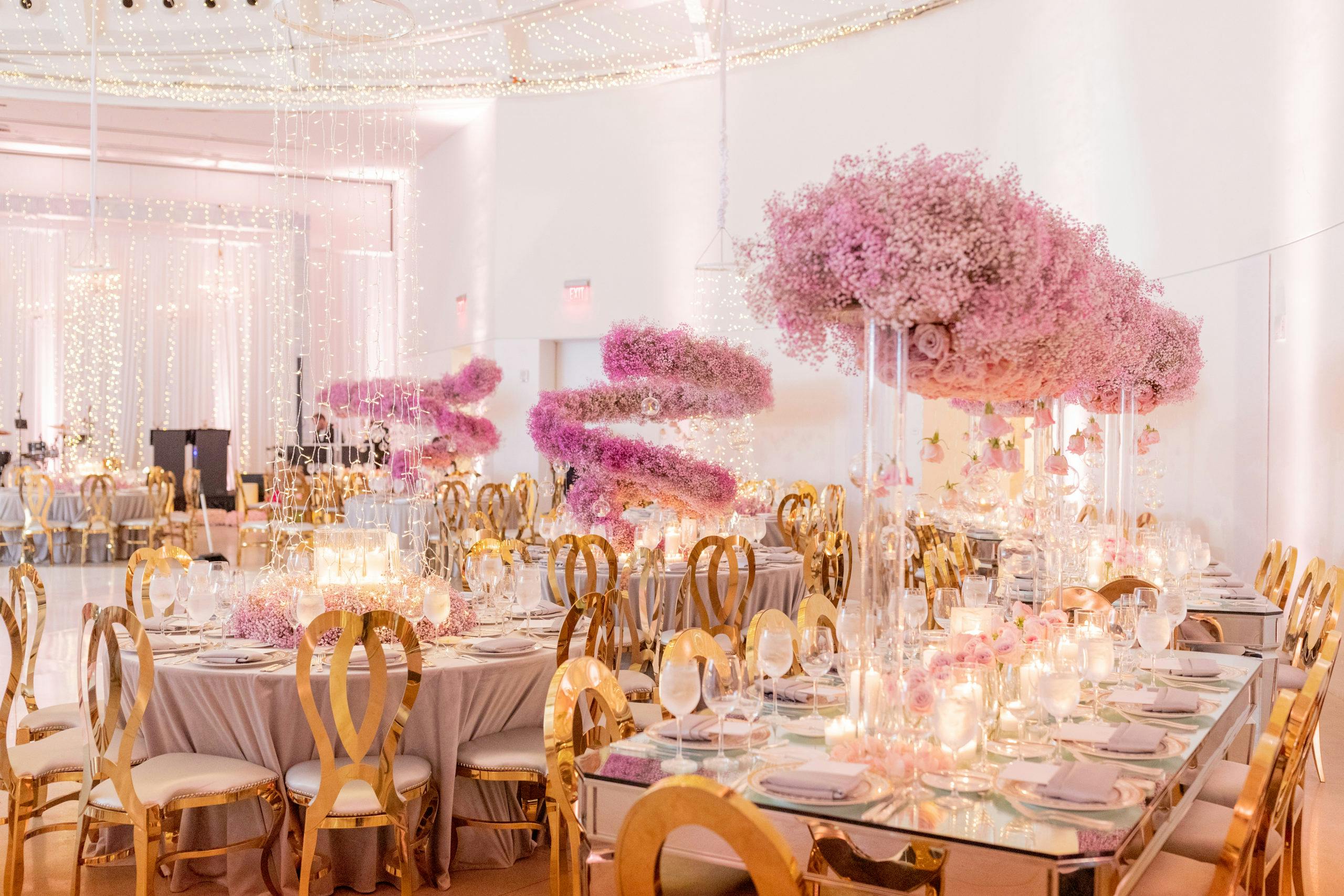 Modern Wedding Reception with Gold Tablescapes and Pink Corkscrew Baby’s Breath Centerpieces | PartySlate