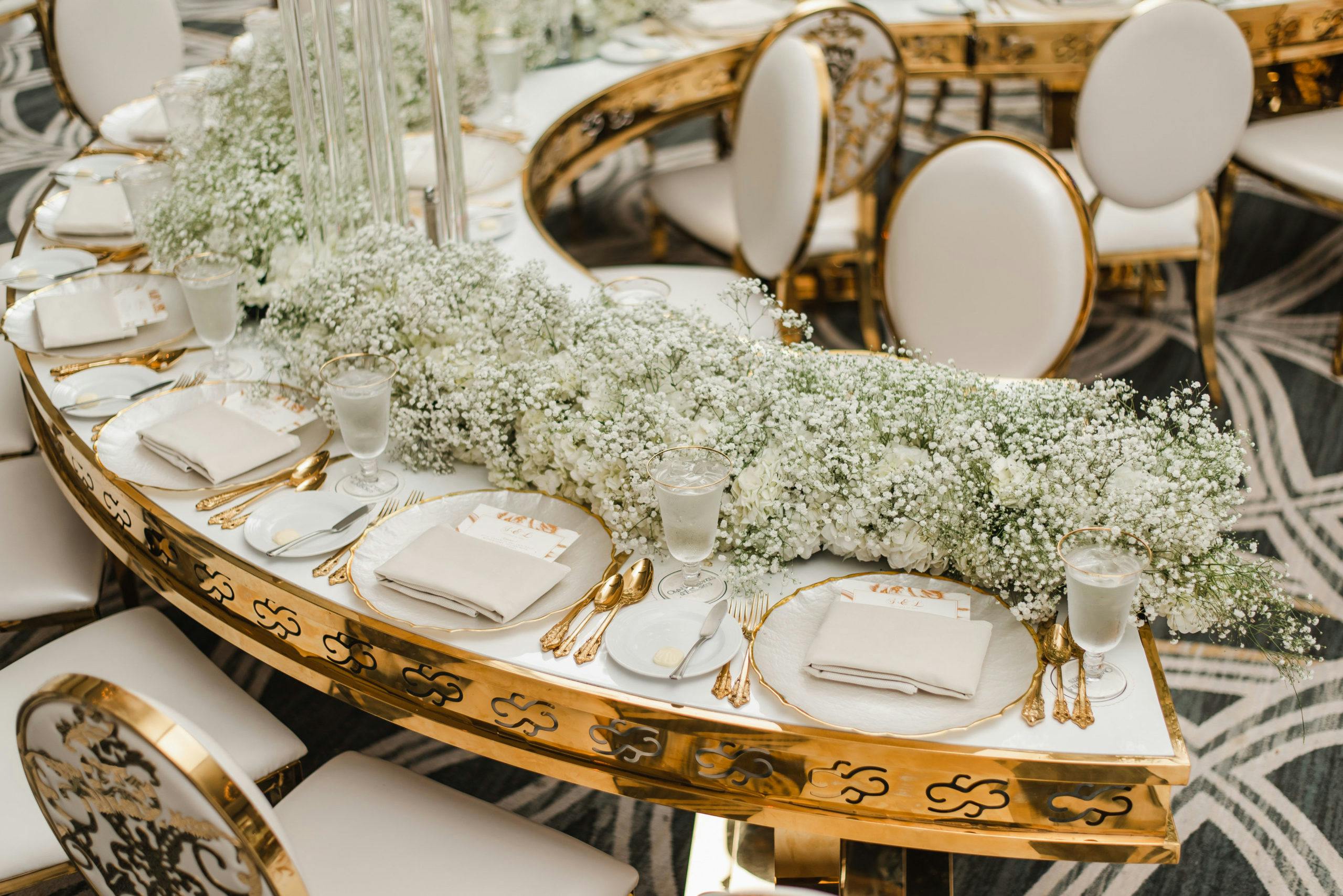 Mod Gold and White Crescent-Shaped Wedding Reception Tables with Baby’s Breath Garland Centerpiece | PartySlate