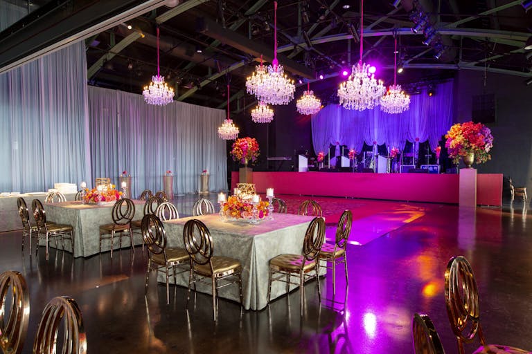 Wedding Reception with Elegant, Industrial-Vibe and Pink Uplighting at Theater on the Lake in Chicago, Illinois | PartySlate