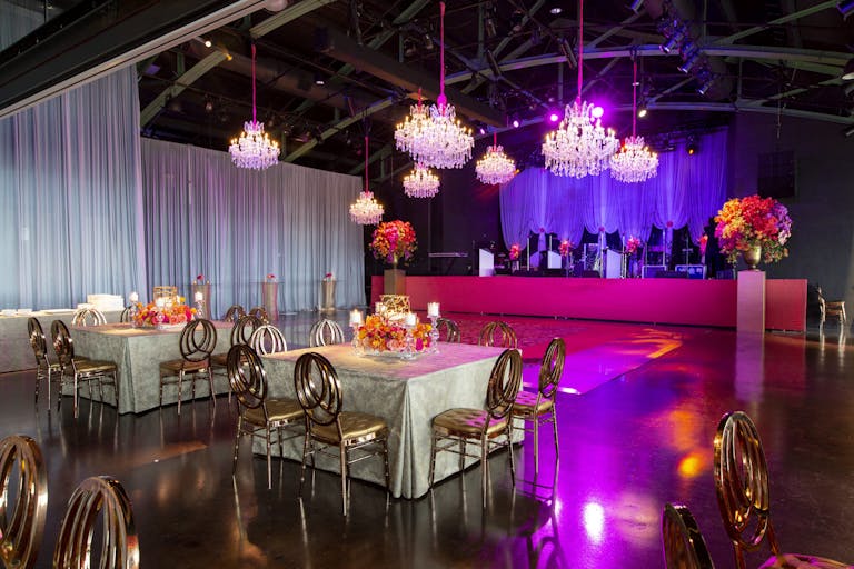 Wedding Reception with Elegant, Industrial-Vibe and Pink Uplighting at Theater on the Lake in Chicago, Illinois | PartySlate