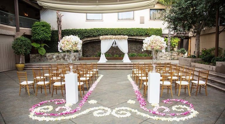 Floral Aisle Decor at DoubleTree by Hilton Hotel Claremont, CA | PartySlate