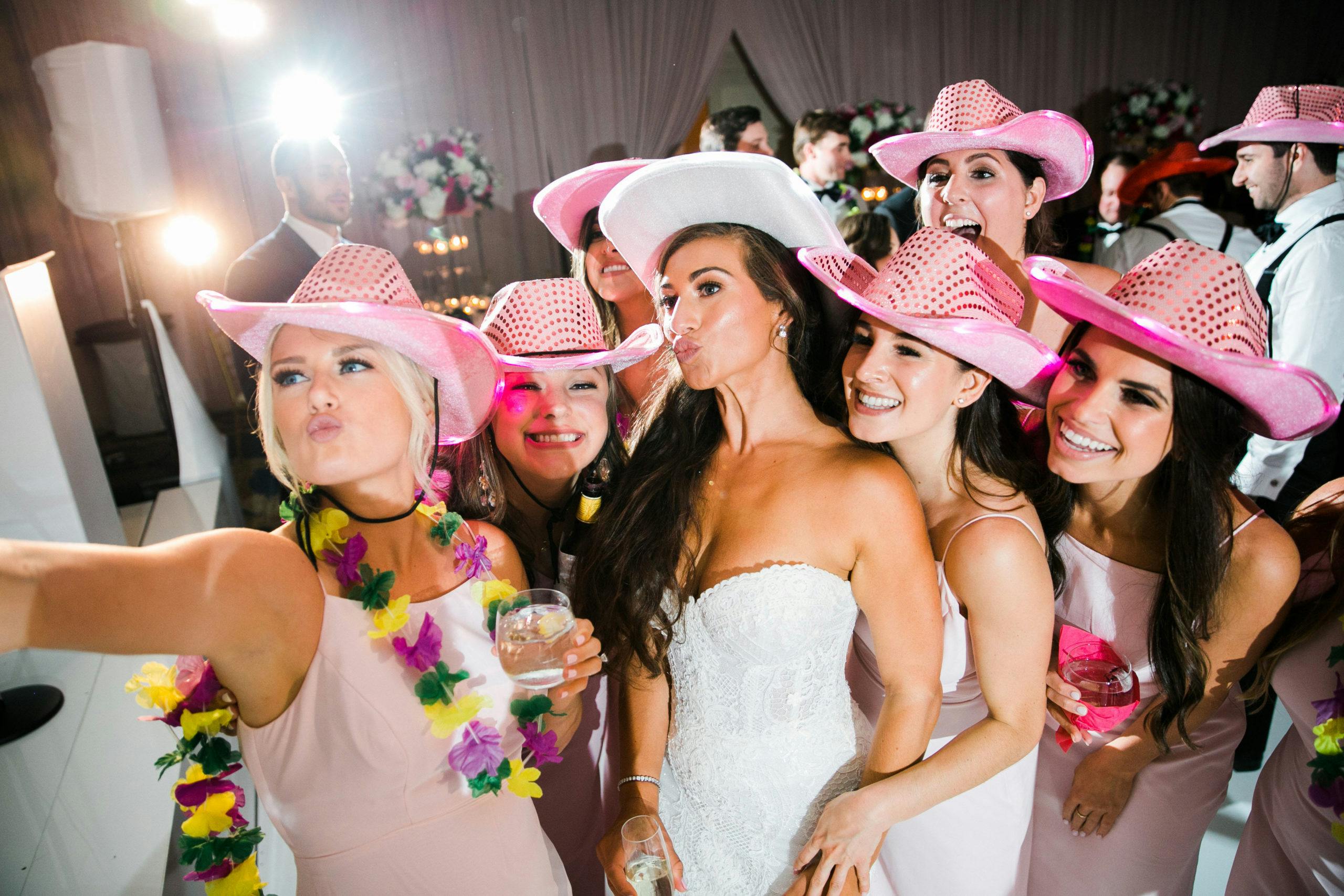 girls take selfie-style photo wearing pink cowboy hats l PartySlate