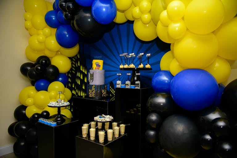 Batman-Themed Kid's Birthday Party With Yellow, Blue, and Black Balloons | PartySlate