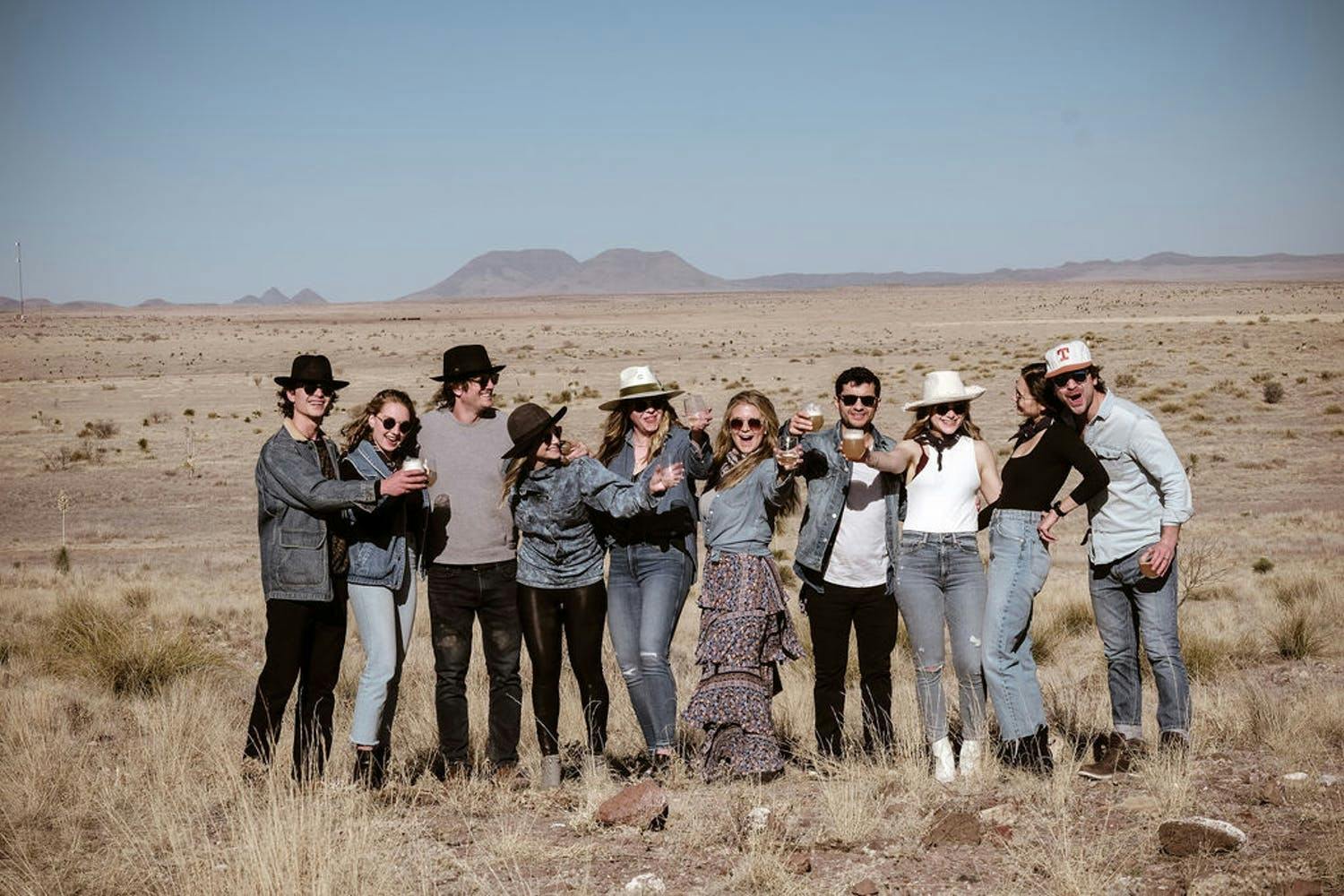 Group of Friends Pose for a Photo Against a Desert Backdrop for a Small Birthday Party | PartySlate