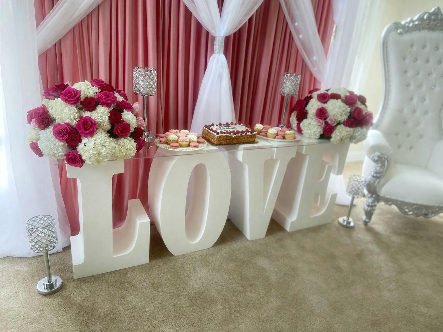 Birthday Dessert Station Laid Out on White Block Letters Spelling Out Love | PartySlate