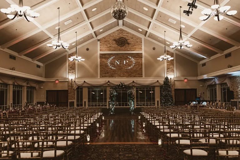 Simple wedding ceremony in barn-style venue with lofty ceilings at Chandler's Banquets in Schaumburg, IL | PartySlate