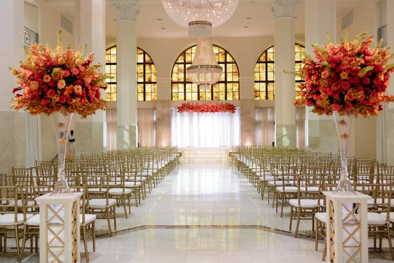 Opulent Wedding Ceremony With Bright Warm-Hued Florals in Southern Exchange Ballroom, one of Atlanta’s Wedding Venues | PartySlate