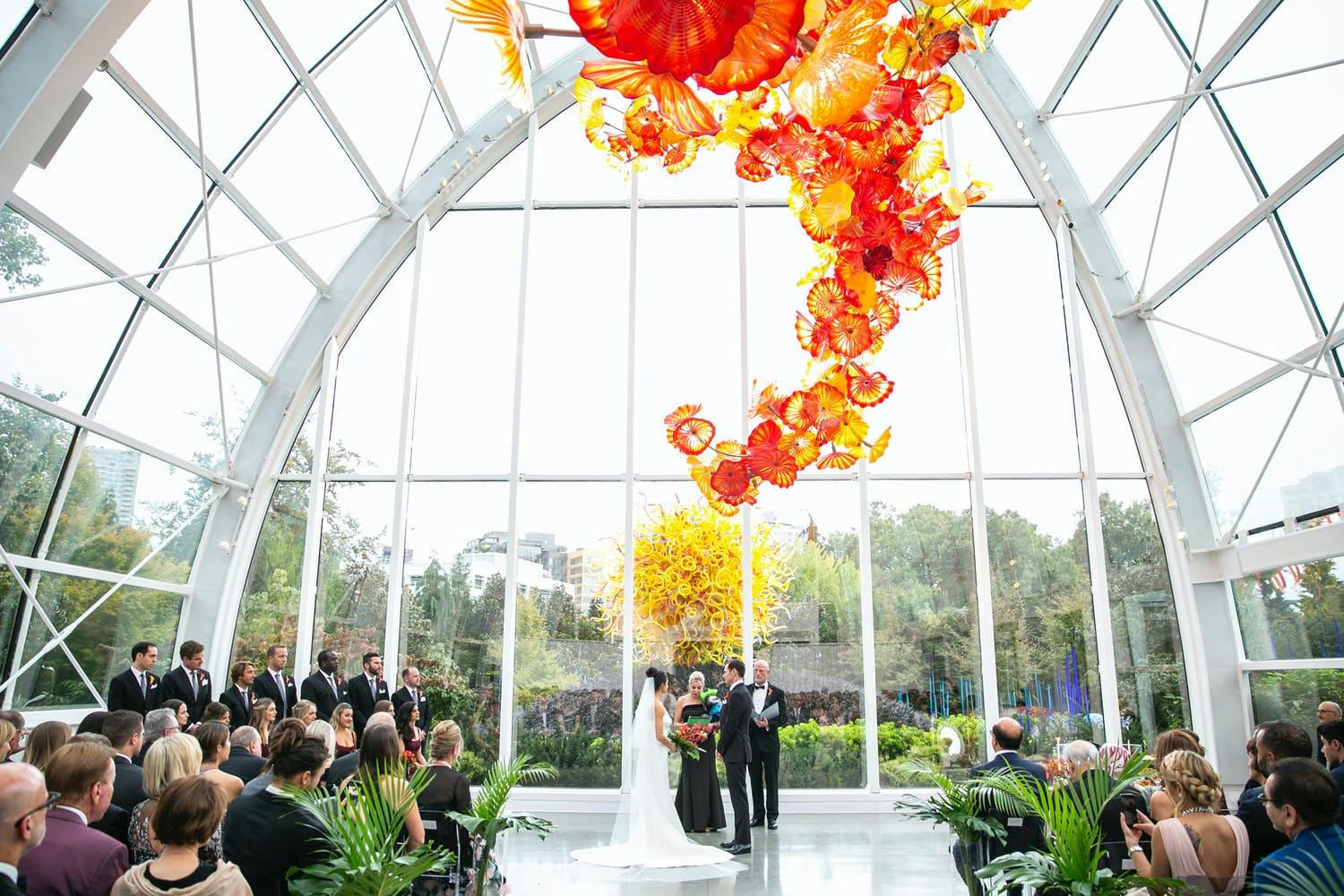 Chihuly Garden and Glass Wedding with Orange Glass Ceiling Installation | PartySlate