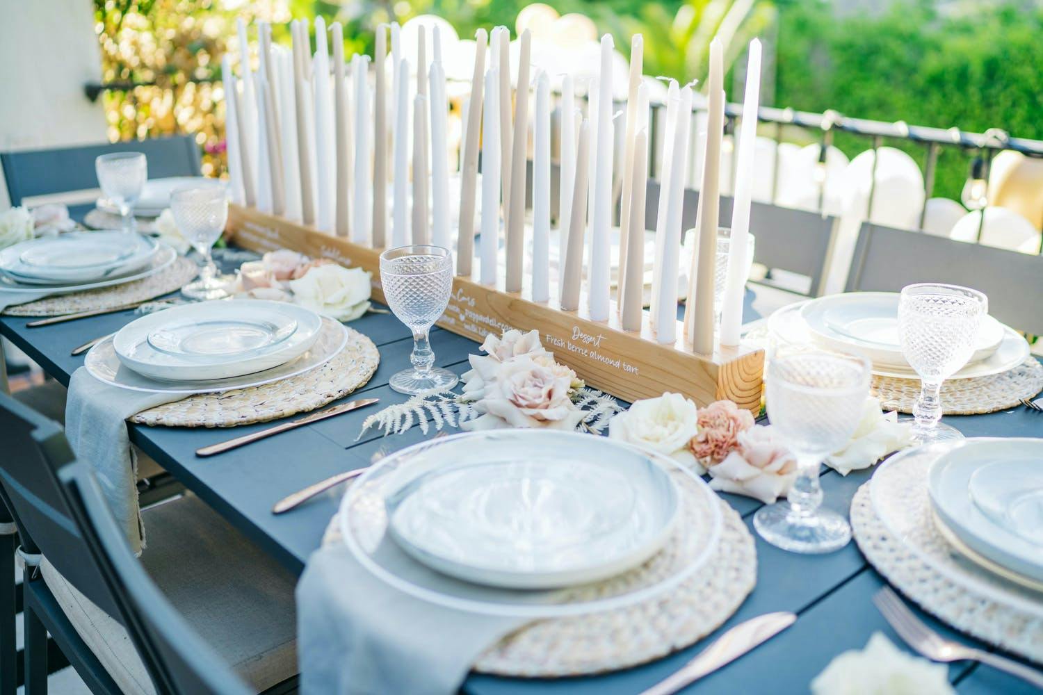Tablescape with Custom Menu and Seating Chart Printed on Wooden Candle Holder with Pastel Candles for Birthday Party | PartySlate