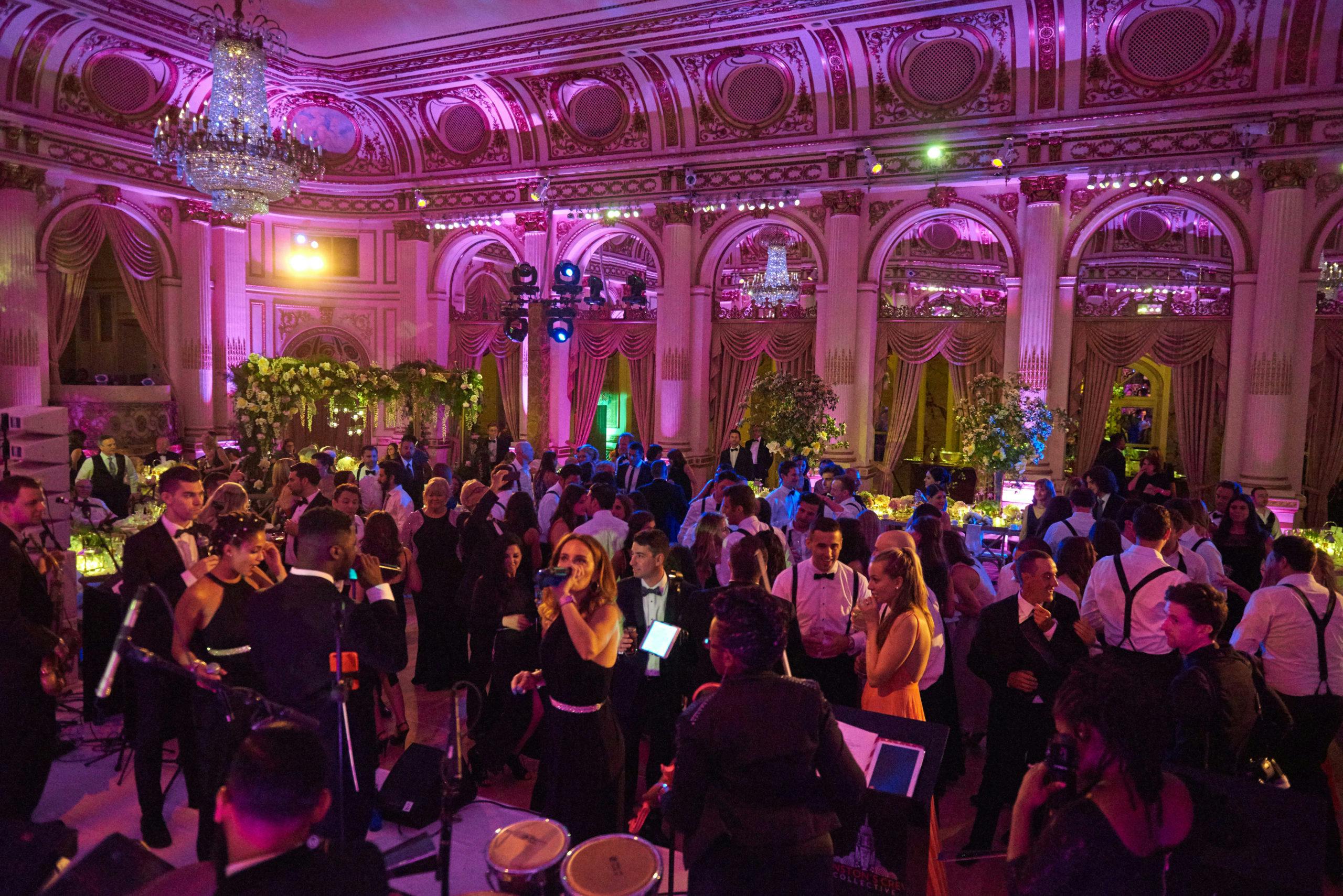 Reception venue filled with people on dance floor l PartySlate