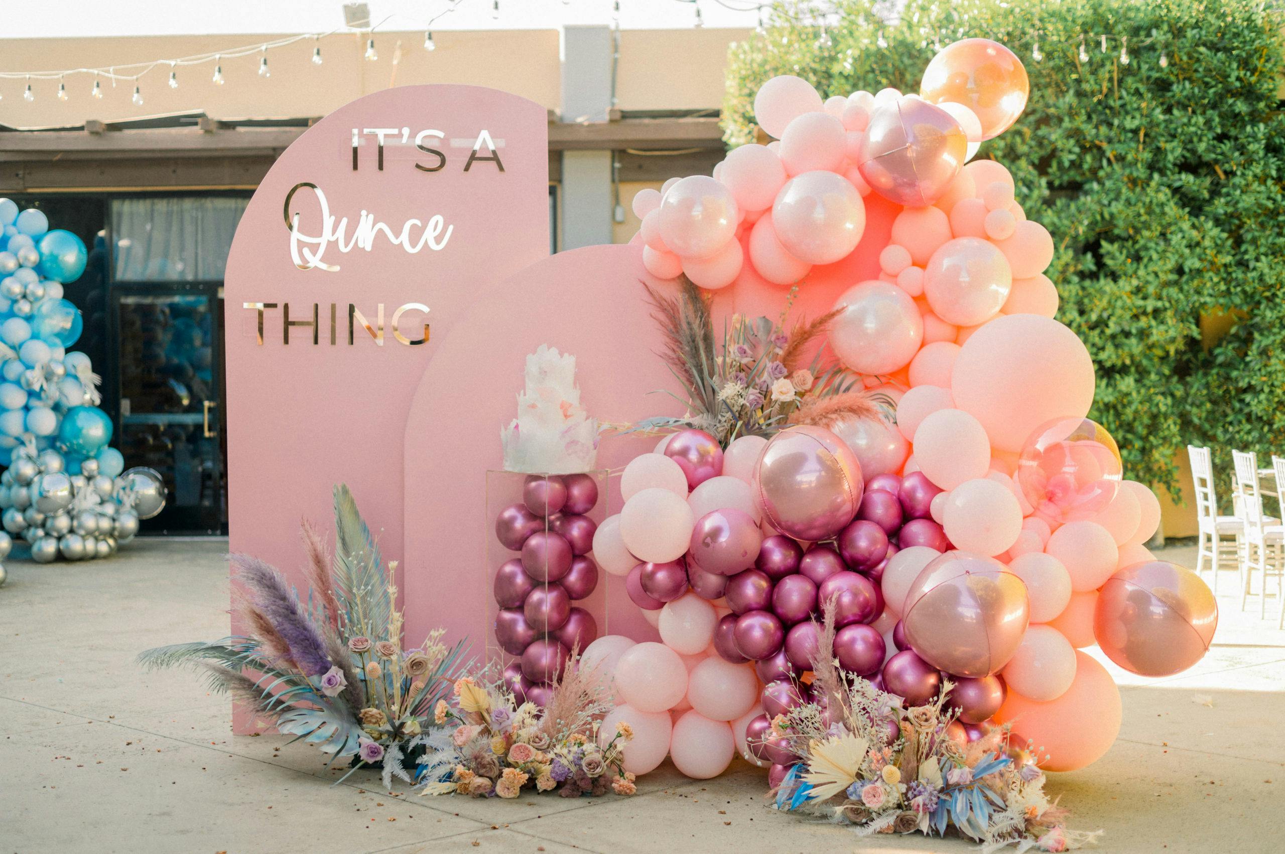 Pink Boho-Chic Backdrop With Magenta and Peach Balloons and Tie Dyed Pampas Grass for Quinceañera | PartySlate