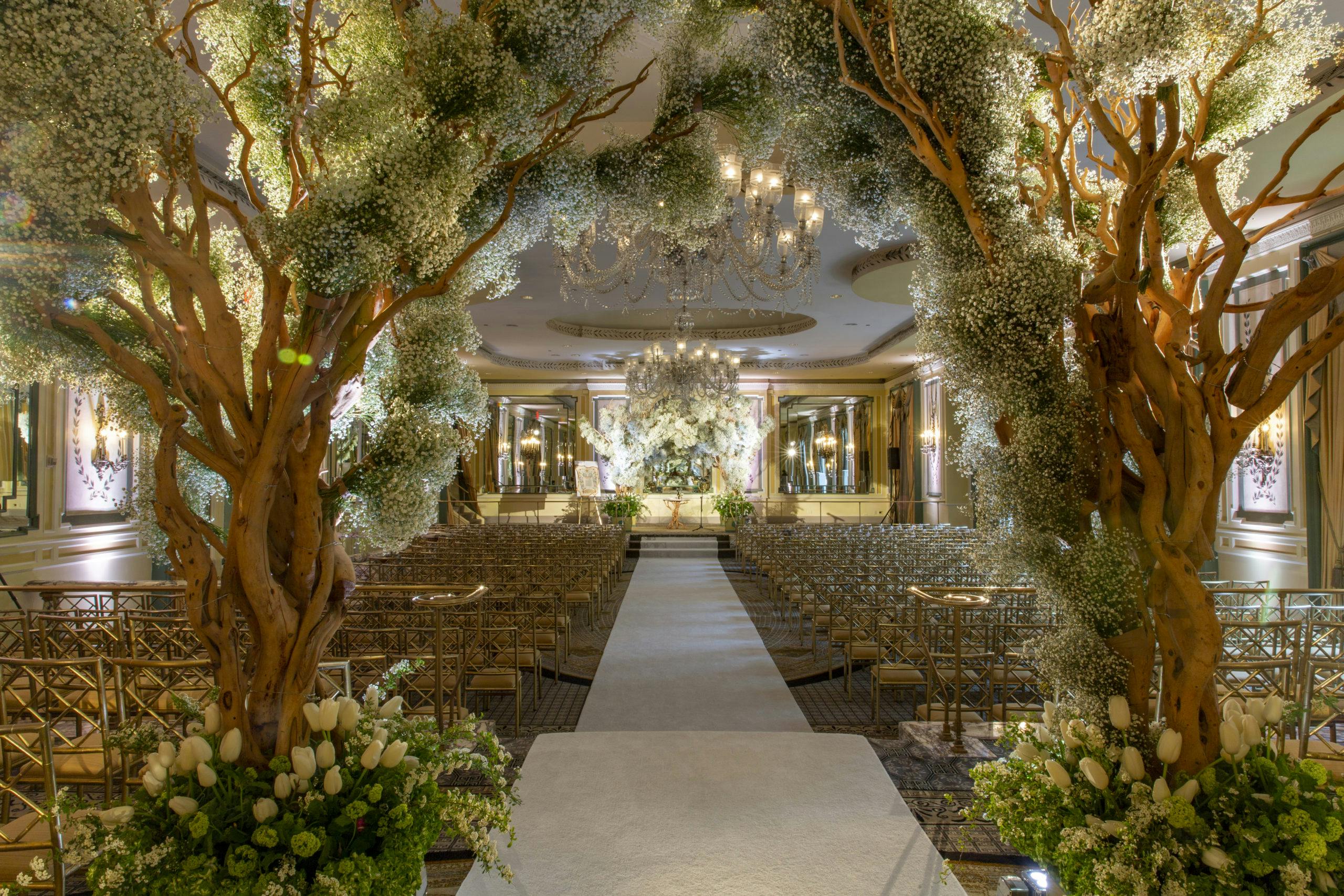 Greenery wedding aisle with two trees for entrance l PartySlate