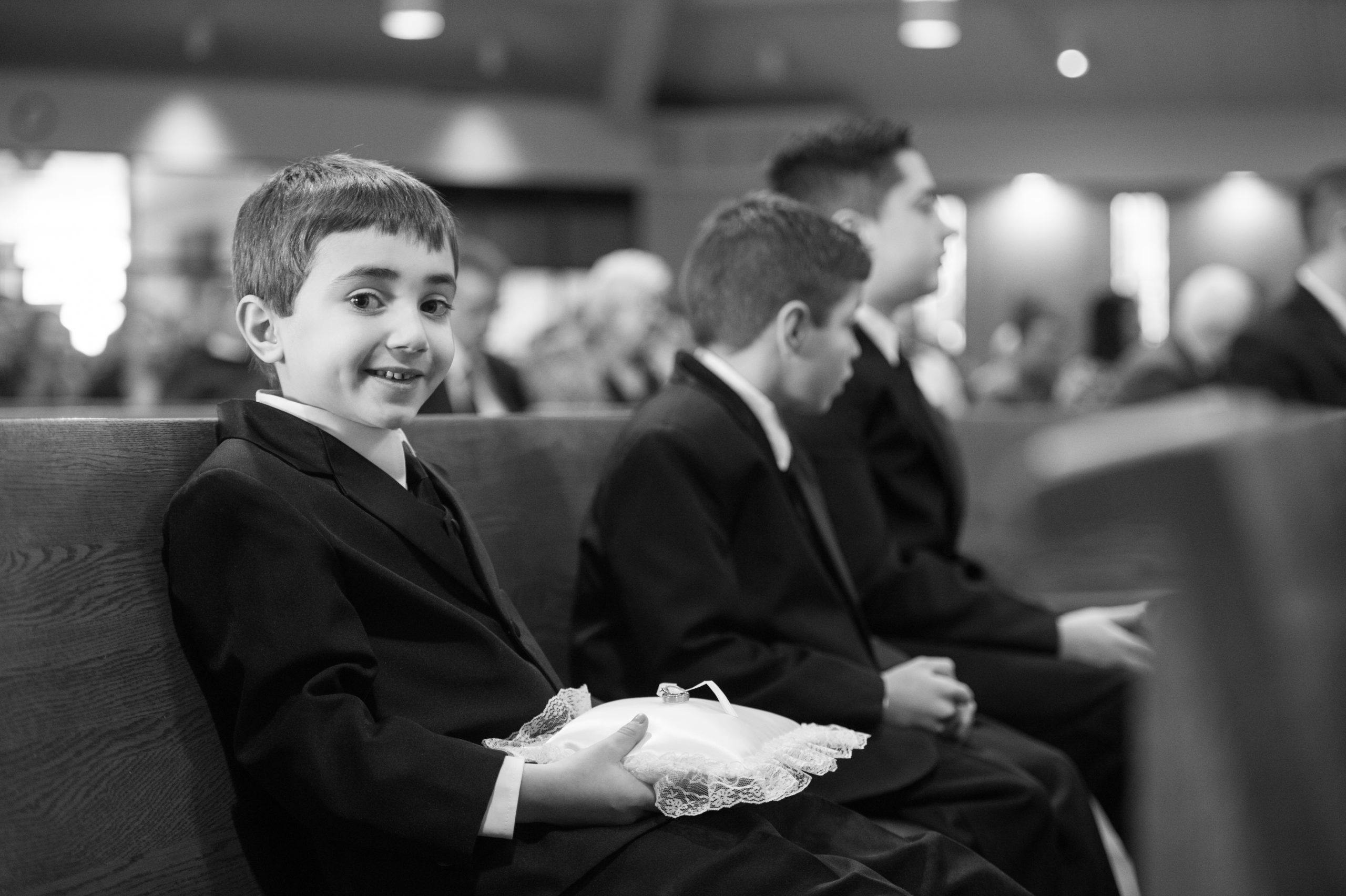 Black and white photo of two young boys sitting in church pue l PartySlate