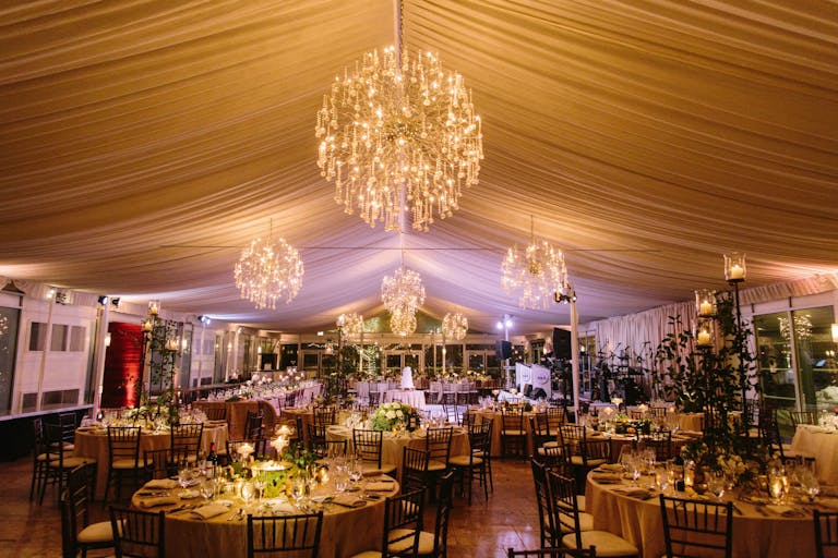 cream hued draped ceiling with starburst chandeliers over wedding reception in Chicago | PartySlate