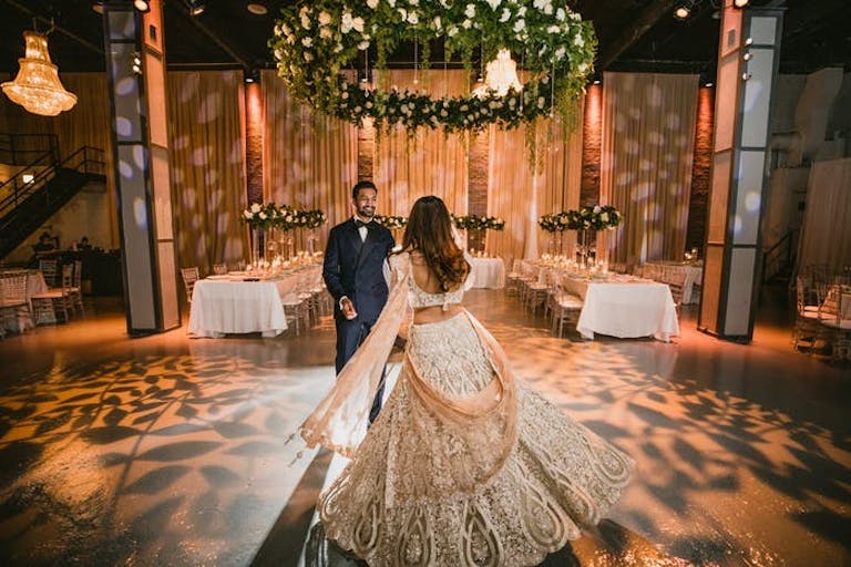 wedding first dance with leafy lighting and greenery ceiling decoration in Chicago | PartySlate
