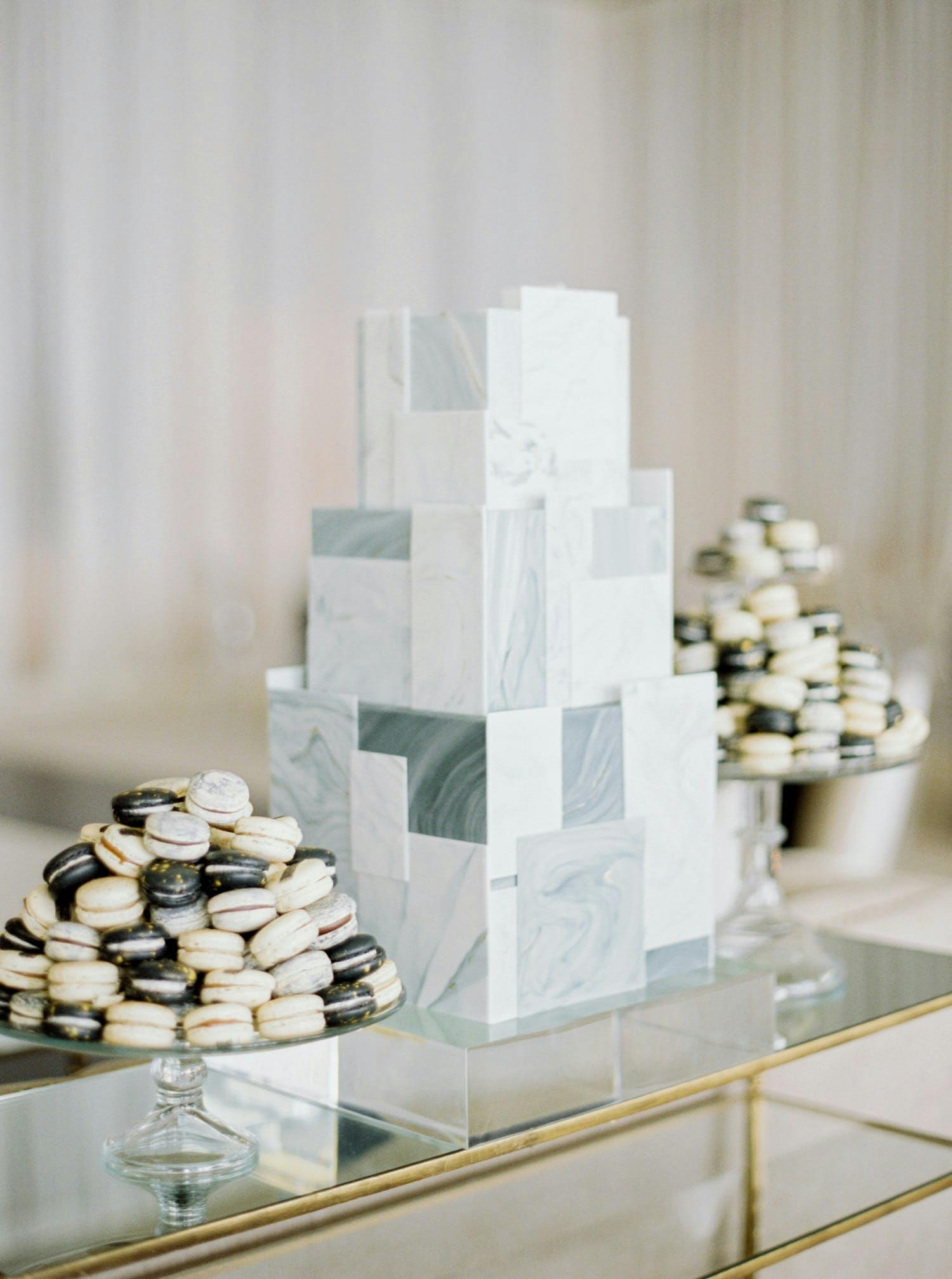 Three-tier grey cake made up of mismatched tile shapes with a marble design | PartySlate