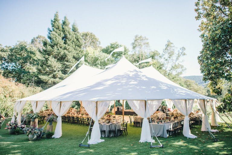 White canopied reception area on manicured lawn surrounded by greenery at Annadel Estate Winery in Santa Rosa, CA | PartySlate