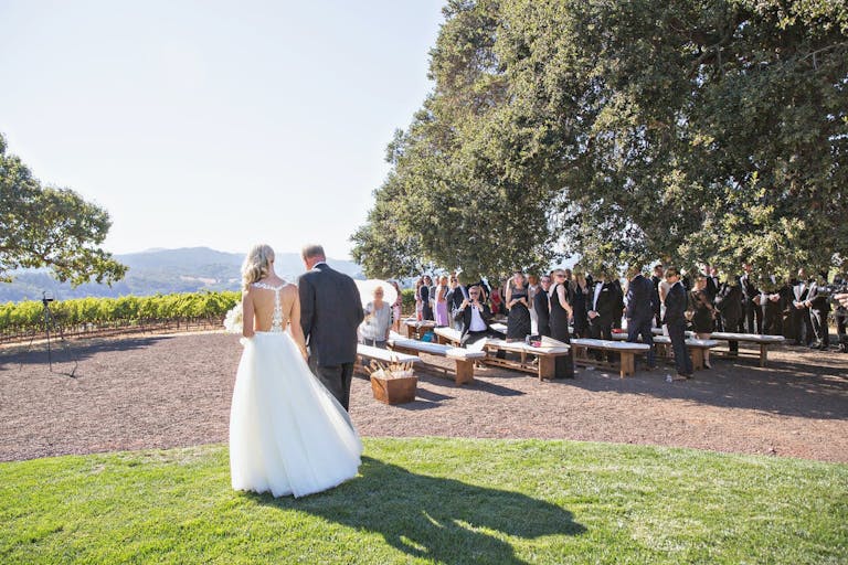 Bride given away at outdoor vineyard wedding as guests admire at Kunde Family Winery in Kenwood, CA | PartySlate