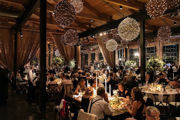 Wedding Reception with Orbed Rustic Lighting at The Foundry at Puritan Mill in Atlanta, GA | PartySlate