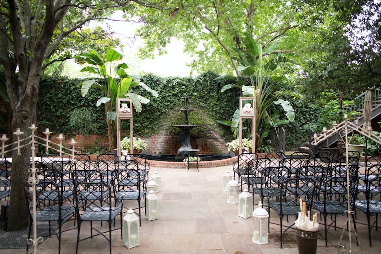 Outdoor wedding reception in romantic courtyard with greenery at Brennan's of Houston | PartySlate