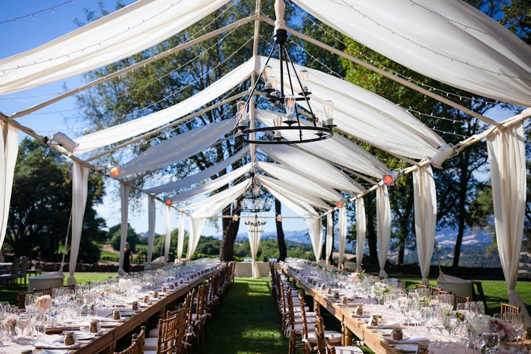 Outdoor reception under the shade of draping white tapestry at Chalk Hill Winery in Sonoma | PartySlate