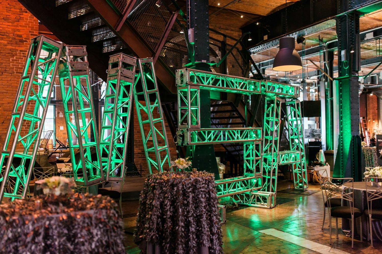 Mine Safety Appliances Company's 100 Year Celebration with Green Geometric Décor Uplit Structure Spelling Out MSA | PartySlate