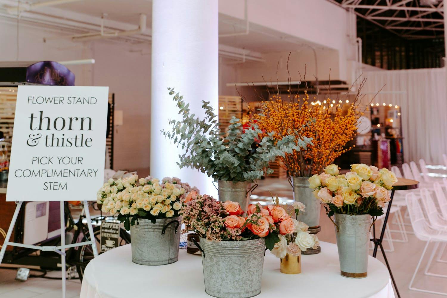 Flower stand where guests can pick a stem as a party favor at Mayfair Centre launch in Vancouver | PartySlate
