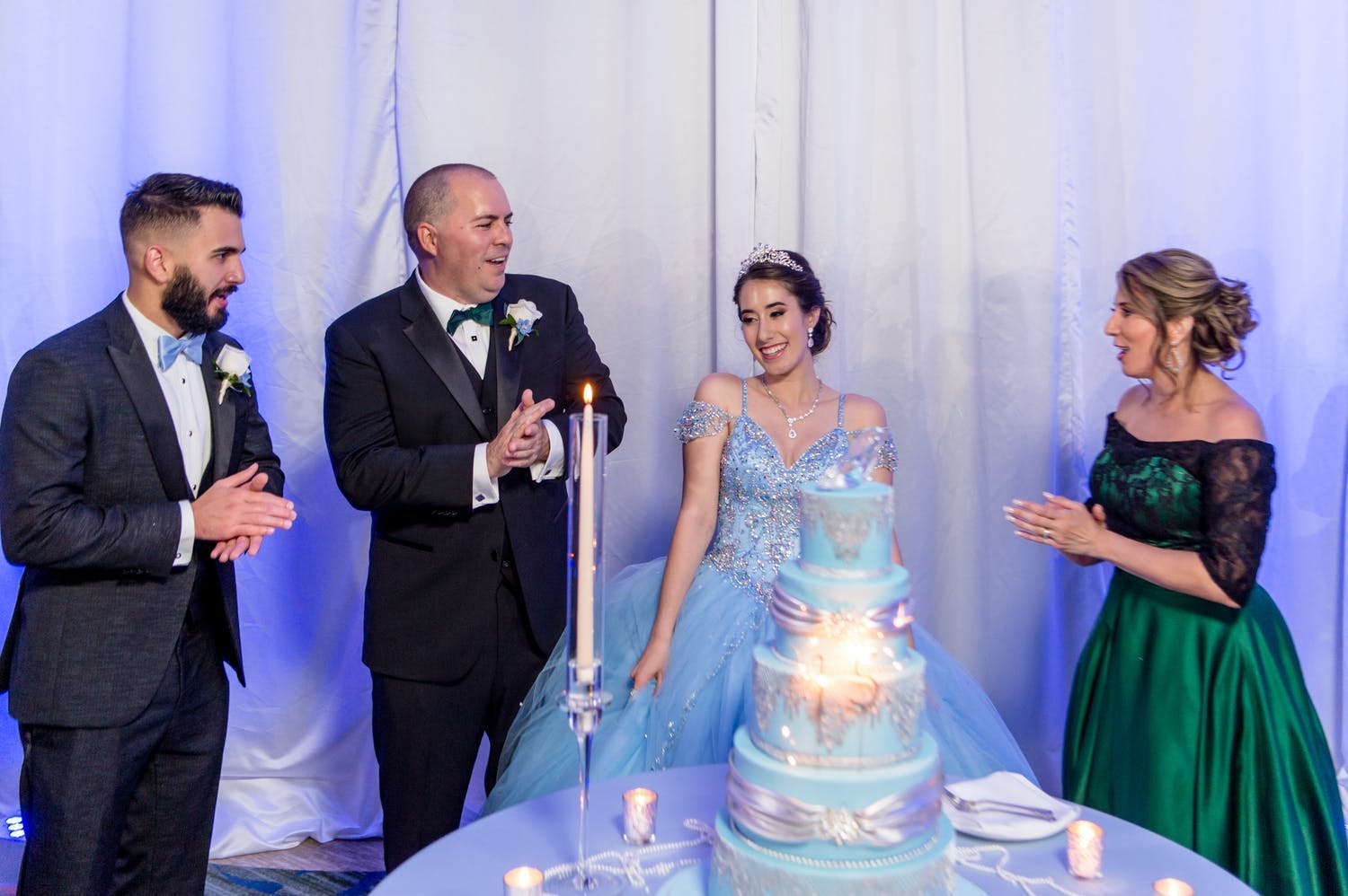 15 candle ceremony for quinceañera as she's watched by chambelan and parents | PartySlate