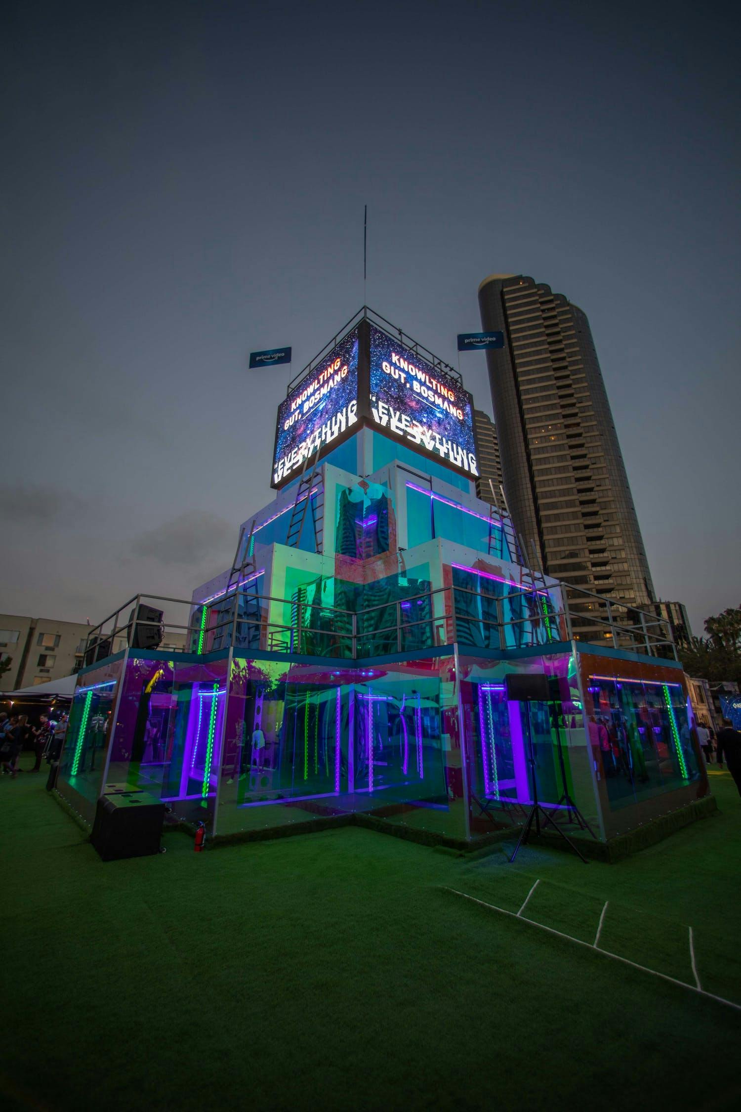 Taking place on a terrace in a city, LED screens are on top of a tower and colored screens are staggered on the rest for private event | PartySlate