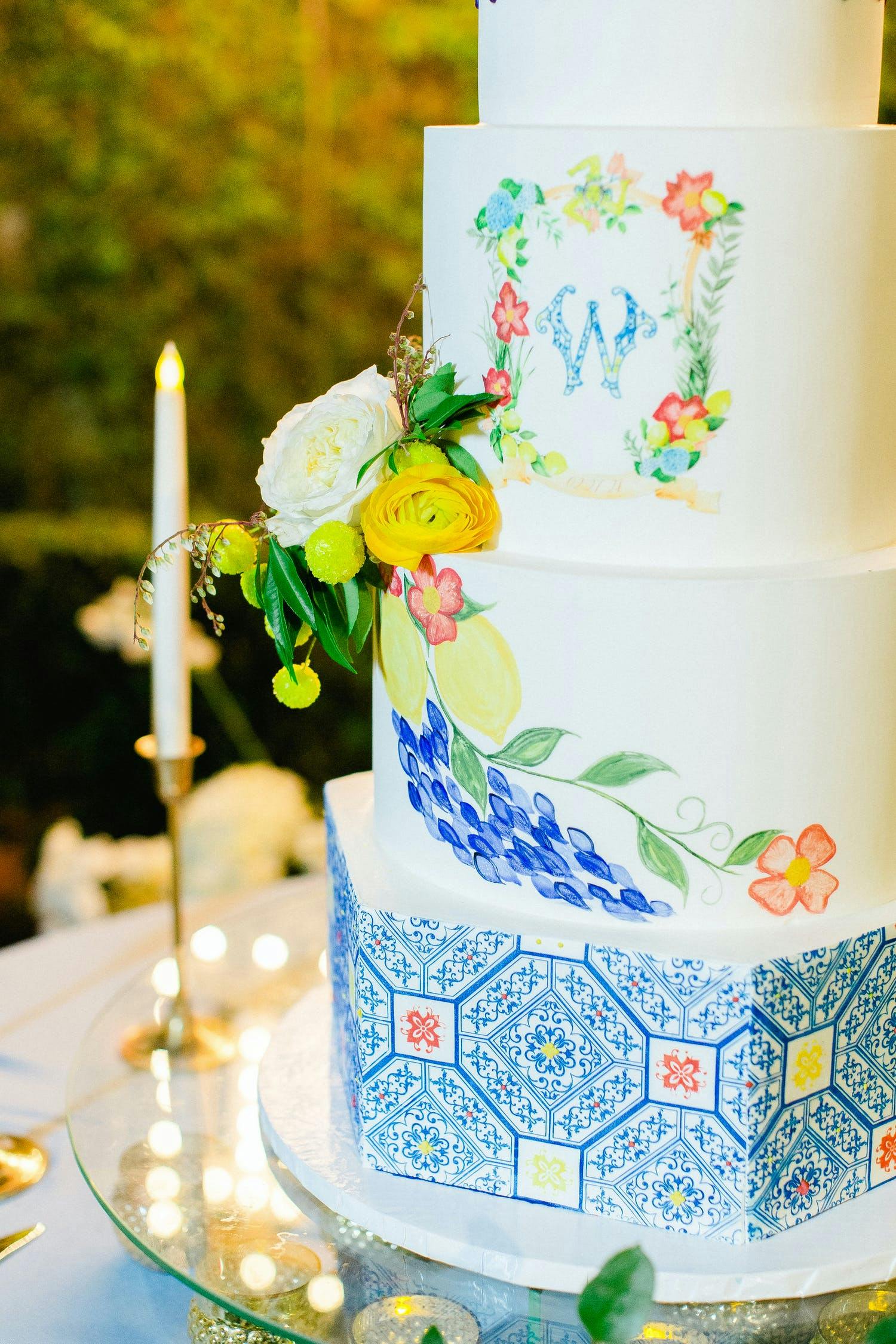 Five-tier French-inspired cake with blue accents and lemon designs | PartySlate