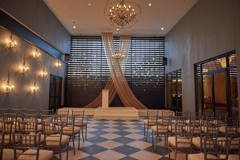 Modern Wedding Ceremony with Simple Sheer Drapery at Flourish by Legendary Events in Atlanta, GA | PartySlate